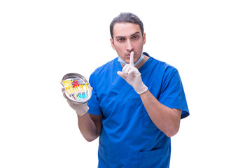 Obraz premium Young handsome doctor with syringe isolated on white 