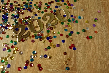 Happy New Year 2020 concept with golden digits and colorful shiny ornaments