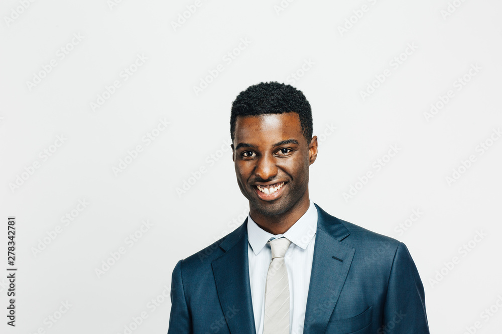 Wall mural Portrait of a smiling, happy man in suit and tie looking at camera, isolated on white studio background