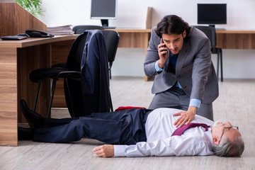 Male employee suffering from heart attack in the office 