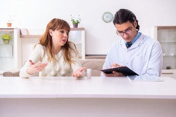 Young female patient discussing with male psychologist personal 
