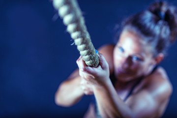 Woman athlete exercising on gymnastic rings