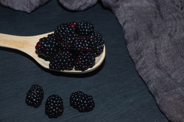 blackberries in a bowl on wooden table