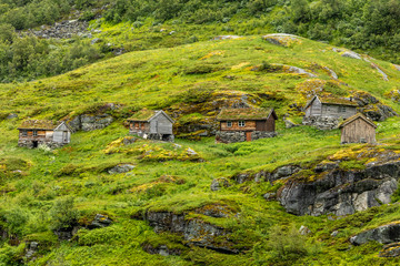 Norwegian mountain village with traditional turf roof houses, Geiranger, Sunnmore region, More og...