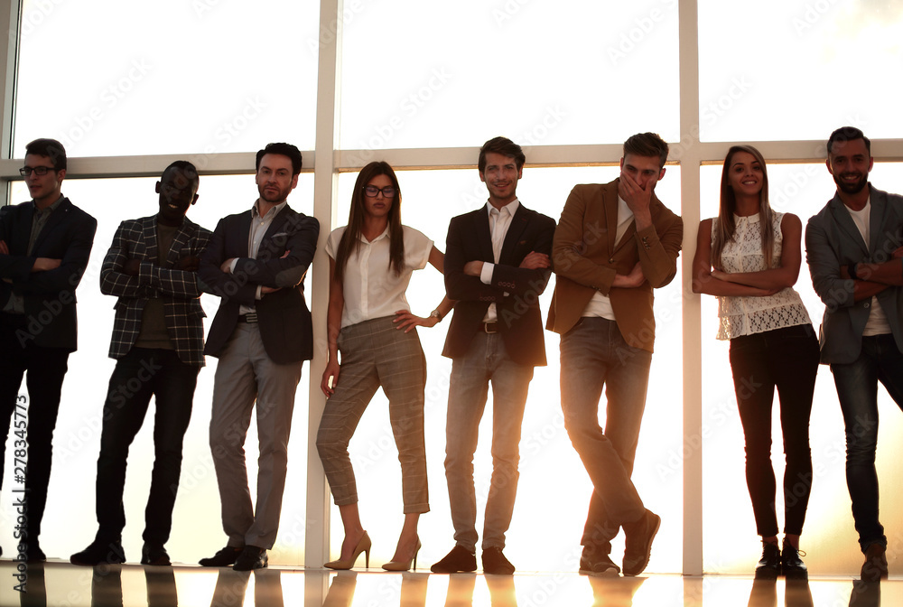 Canvas Prints group of young people standing in an office with a large window