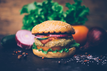 Vegetarian burger (home made burger) with chickpea cutlet and vegetables. Veg concept. Copy space.