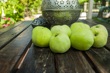 Green apples lying on a wooden table