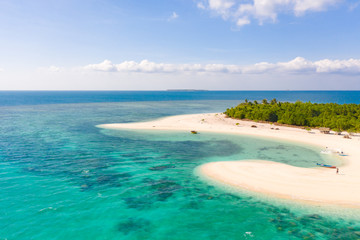 Patawan island. Small tropical island with white sandy beach. Beautiful island on the atoll, view from above. Nature of the Philippine Islands.