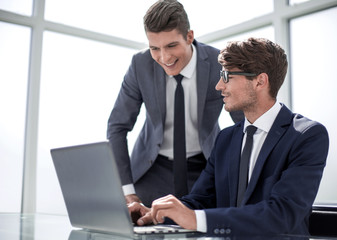 employees use a laptop to check the information they need