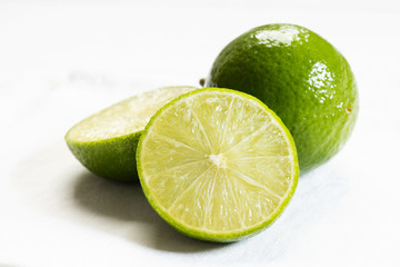 Fresh green limes on white background