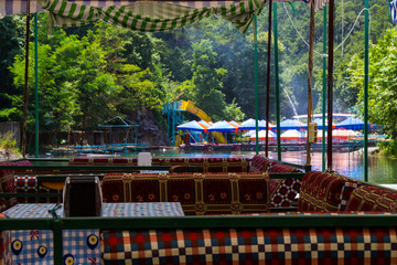 Fototapeta premium Cafe on the water. Gazebos in the bed of a mountain river. Turkish Restaurants
