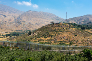 Israel Syria border fence facing a UN observing station on the Syrian side