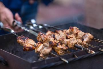 Cooking shashlik on the mangal in nature. Selective focus.