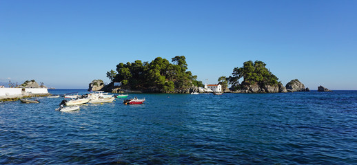 Obraz premium Parga, Greece, July 17 2018 Panoramic view of the small island opposite Parga with the small church