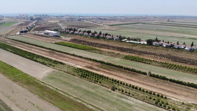Aerial view approaching a row of houses near a field in Turkey
