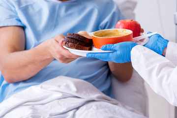 Male patient eating food in the hospital 