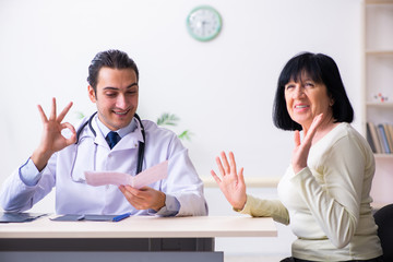 Young doctor examining senior old woman
