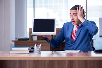 Young handsome businessman sitting in the office 