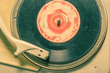 Old record player with few black vinyl records