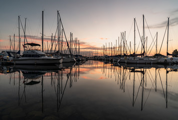 Fototapeta na wymiar A new day starts as the boats rest during sunrise