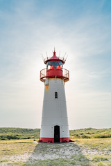 Lighthouse red white on dune.