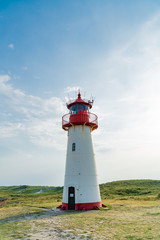 Lighthouse red white on dune.