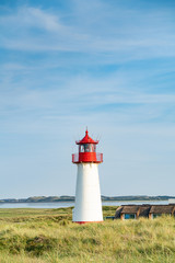 Lighthouse red white on dune.