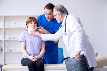 Obraz premium Two doctors examining young woman 