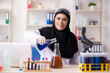 Female chemist in hijab working in the lab