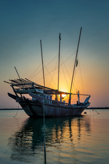 Beautiful Sunrise Boat in seaside with yellow and blue sky background. Dammam -Saudi Arabia