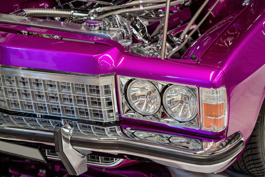 Close Up Of Front Of Hot Pink Metallic Classic Car