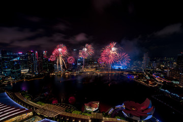 Obraz na płótnie Canvas Aerial view of Singapore national day fireworks celebration at Marina Bay cityscape