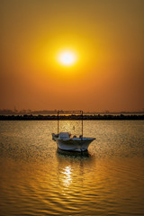 Fototapeta na wymiar Beautiful Sunrise Boat in seaside with yellow sky. Dammam -Saudi Arabia