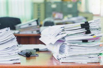 Heap of papers work stack documents on office desk ,business documents billing and examination to report the summary results annual report for presented. Business offices concept