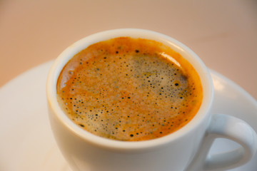 Espresso coffee in a white mug