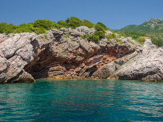 Fototapeta premium Rocky shores and blue Adriatic sea near the town of Budva, Montenegro