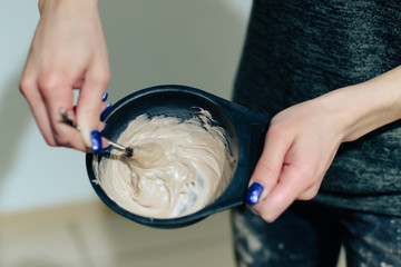 stylist's work with the hair of a girl in a beauty salon
