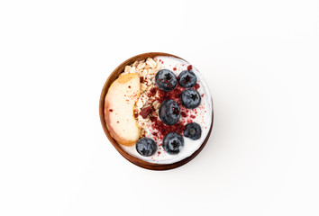 Granola, oatmeal with milk, peach and blue berry on isolated white background