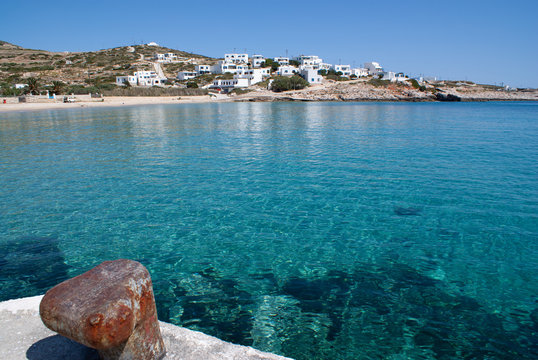 Greece, the secluded island of Donoussa. A view of the peaceful and beautiful town beach. The crystal clear blue waters of the Aegean sea on a sunny spring day.
