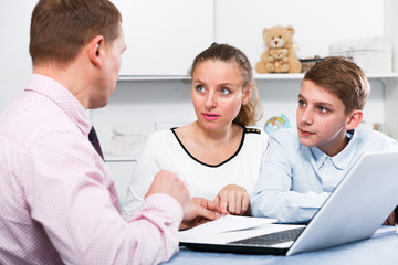 Fototapeta premium Mother and son signing documents