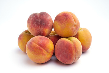 Several peaches isolated on white background.