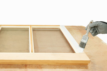 Close up of a person painting restored sash windows.