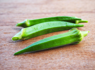 Close up of fresh okra on a wooden table.