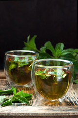 Cups of hot tea  with  mint herb, selective focus