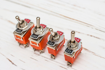 Orange On / Off Switches on White Wooden Background