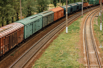 Obraz premium Gravel railway with freight train wagons