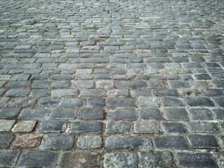 Gray granite paving stones close-up. The texture of the stone.