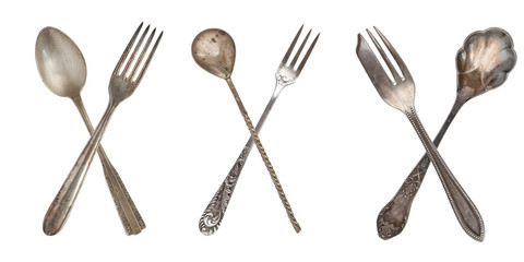 3 set crossed vintage spoon and fork isolated on old vintage background. Rustic style