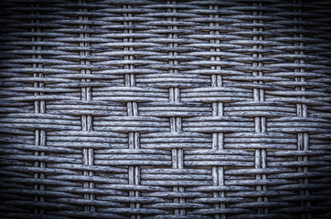 Gray artificial rattan pattern background of structure close-up. Furniture backdrop.