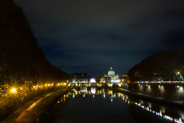 Night scene of Rome, Tevere river with basilica in background